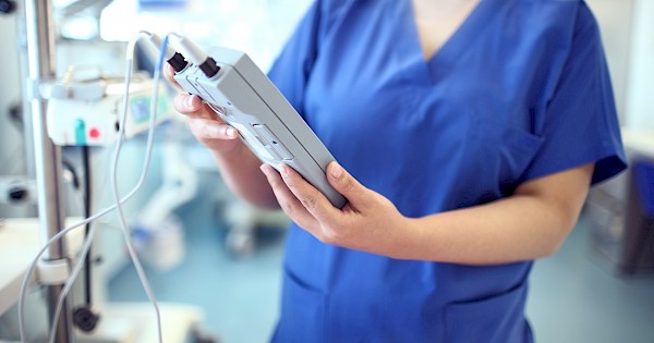 Nurse holding a telemetry monitor