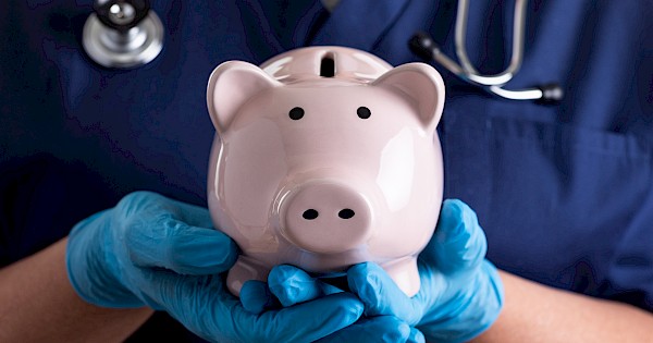 nurse holding a piggy bank